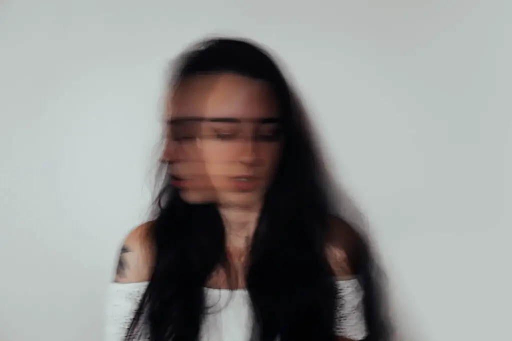 A blurred portrait of a woman, as if in motion