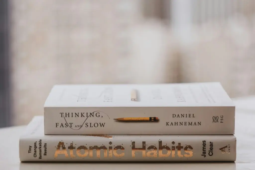 Two books stacked on a pale table