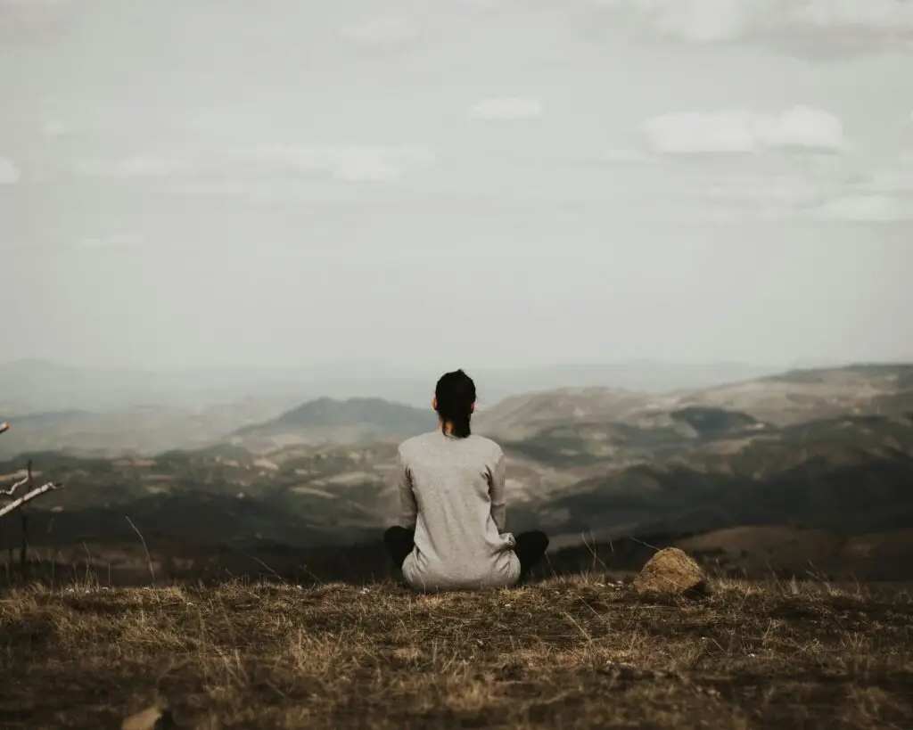 A woman looking out over misty hills