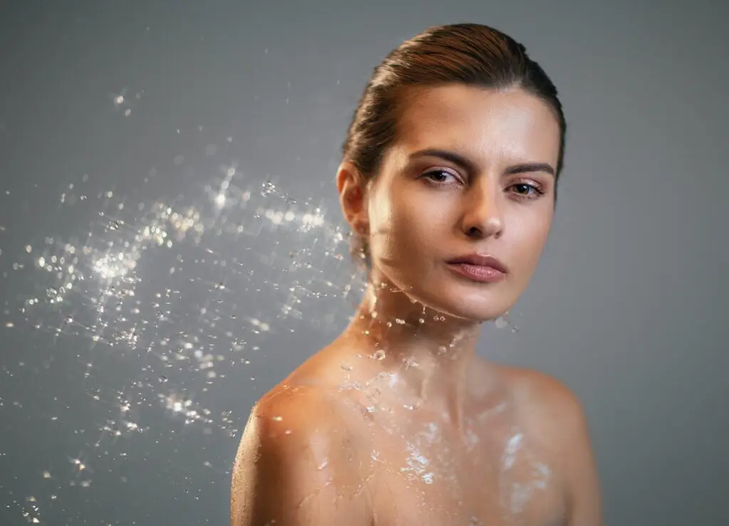 A woman with sparkles of light rising from her skin