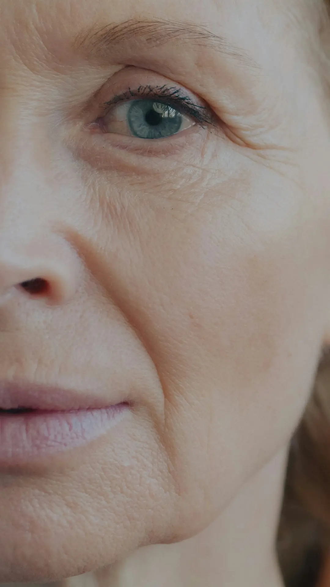 Close-up of an older woman's face in soft light