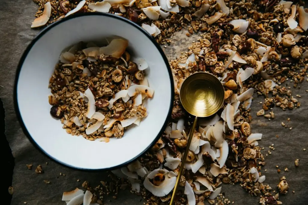 A bowl of granola with seeds, nuts and coconut flakes