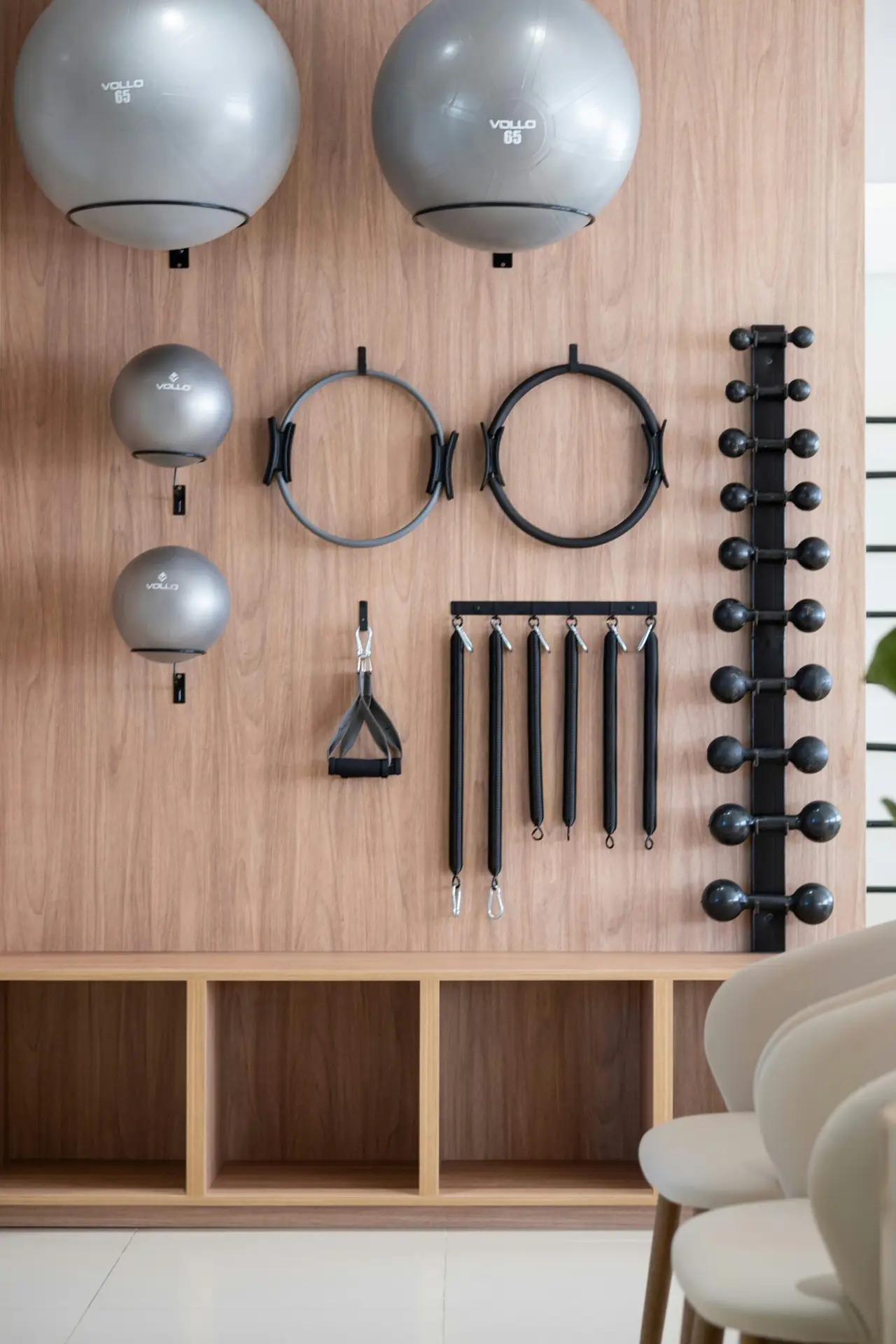 Fitness equipment neatly hung on a wooden studio wall