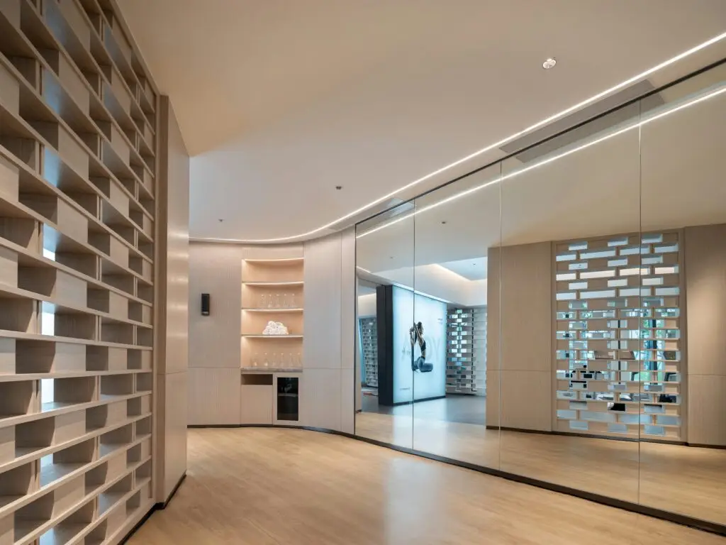 A calm, softly lit boutique fitness studio with timber shelving