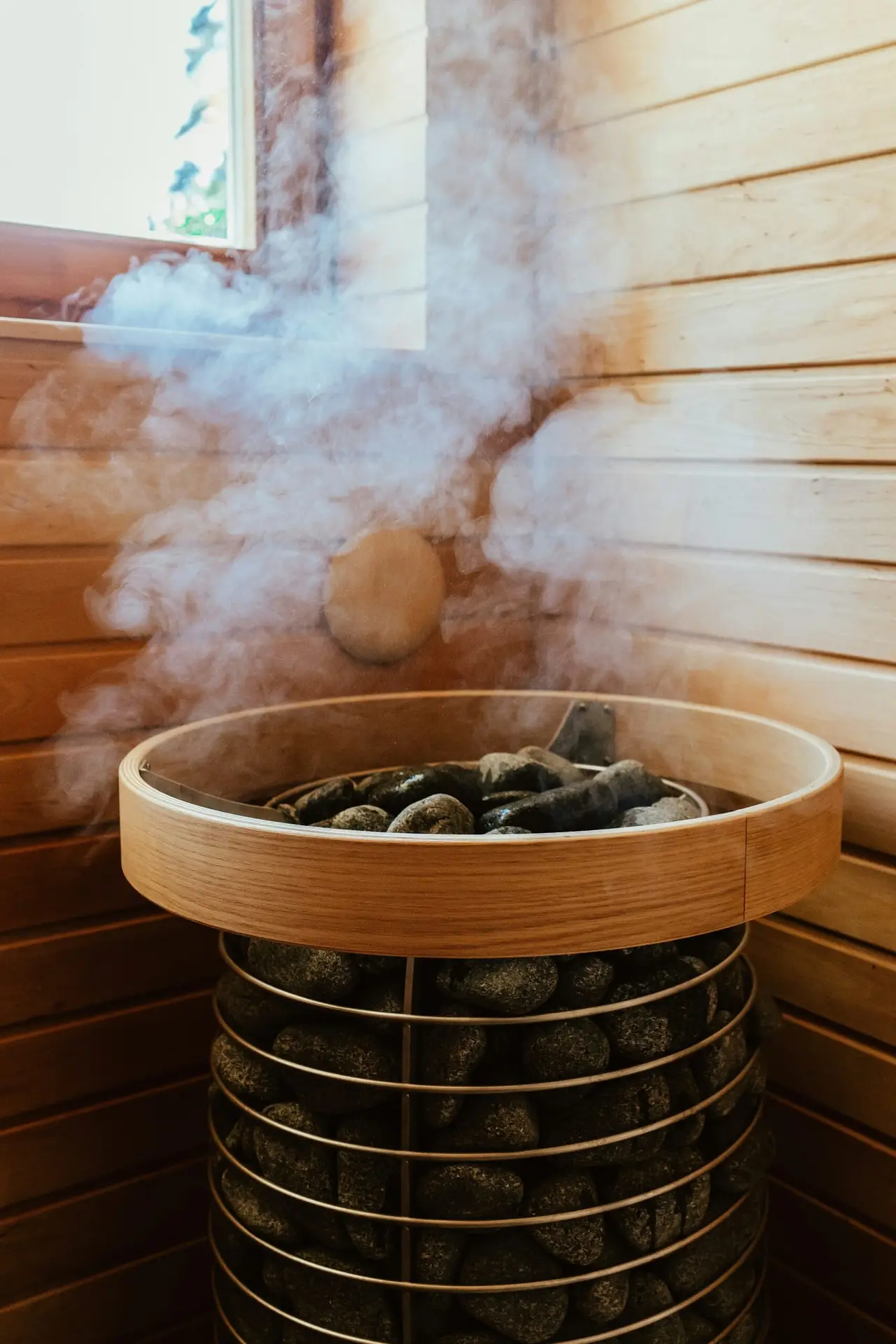 Steam rising from hot sauna stones