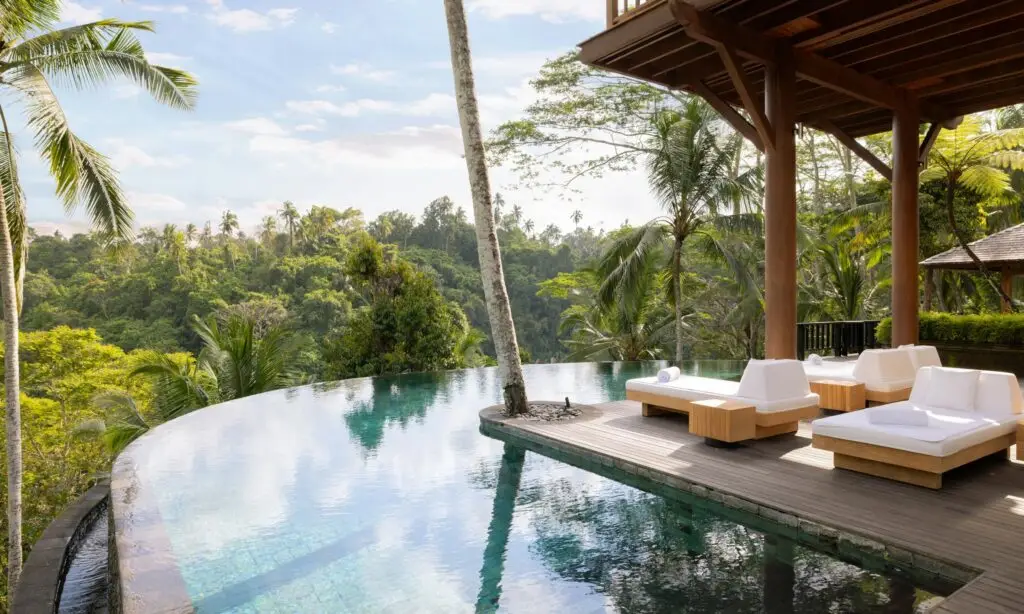 Daybeds beside an infinity pool overlooking the jungle in Bali