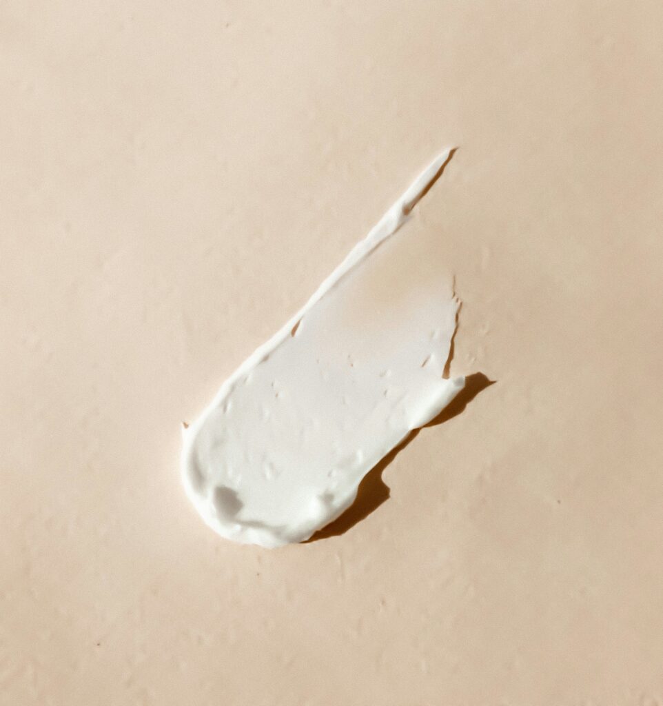 A swipe of rich white cream on a warm neutral background